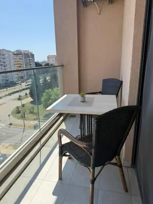 a table and chairs on a balcony with a view at Apartman Luka in Bar