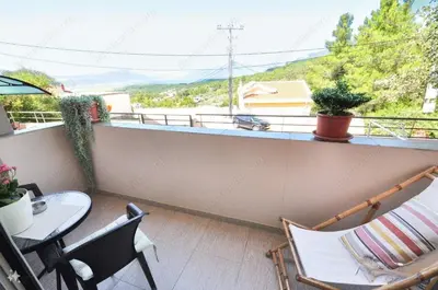 a balcony with a table and chairs and a view at Sunset in Kotor