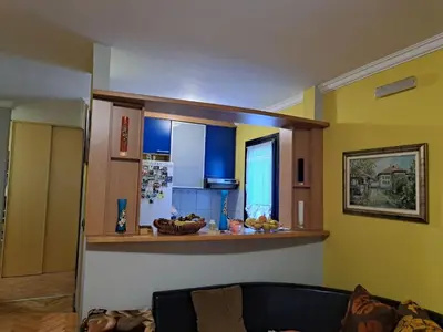 a living room with a couch and a kitchen at Holiday 2 in Kotor