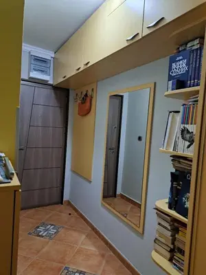 a room with a mirror and a hallway with a door at Holiday 2 in Kotor