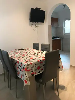 a table with chairs and a table cloth with hearts on it at Čanj apartmani in Čanj