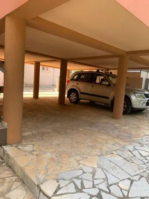 a car parked under a garage with pillars at Čanj apartmani in Čanj