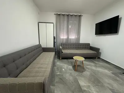 a living room with two couches and a table at Apartman 2 in Bar, Susanj