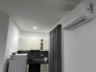 a kitchen with white cabinets and a white refrigerator at Apartman 2 in Bar, Susanj