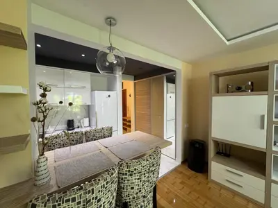 a kitchen with a dining room table and a refrigerator at Comfortable family apartments in Przno in Pržno