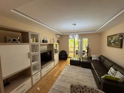 a living room with a couch and a tv at Comfortable family apartments in Przno in Pržno