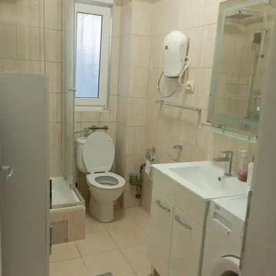 a bathroom with a toilet and a sink and a mirror at Nice summer apartment near sea in Budva