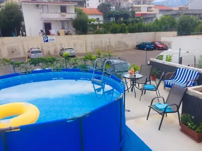 a swimming pool on a patio with a table and chairs at Aparthotel Monterria in Bar