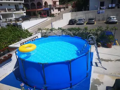 a large blue pool with a frisbee in it at Aparthotel Monterria in Bar