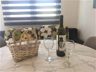 a bottle of wine and two glasses on a table at Aparthotel Monterria in Bar