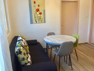 a living room with a couch and a table and chairs at Aparthotel Monterria in Bar