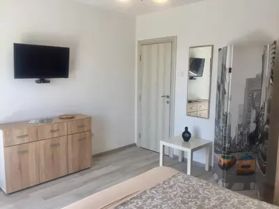 a bedroom with a flat screen tv on a wall at Aparthotel Monterria in Bar