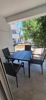 a blue picnic table and chairs on a balcony at Apartmani Aki 3 in Sutomore