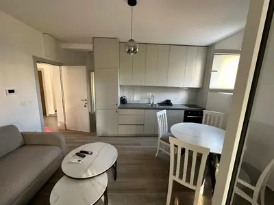 a living room with a couch and a table at Apartmani Aki 3 in Sutomore