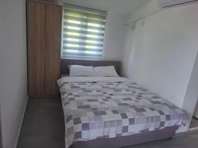 a bedroom with a bed with a checkered blanket at Apartman Andjela 1 in Budva