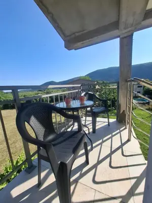 a table and chairs on a balcony with a view at Apartman Andjela 1 in Budva