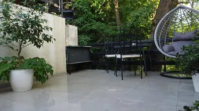 a patio with a chair and a swing at Jelena Lapčići Budva in Budva