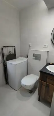 a white bathroom with a toilet and a sink at Jelena Lapčići Budva in Budva