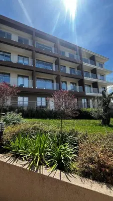 an apartment building with a garden in front of it at Casa Montenegro 1 Plus 1 Suite View Sea and Pool in Kavač