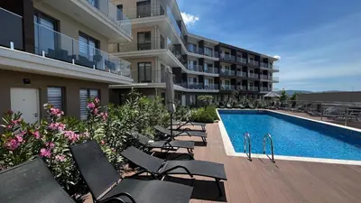 a row of chairs sitting next to a swimming pool at Casa Montenegro 1 Plus 1 Suite View Sea and Pool in Kavač
