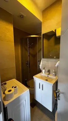 a bathroom with a shower and a white sink at Casa Montenegro 1 Plus 1 Suite View Sea and Pool in Kavač