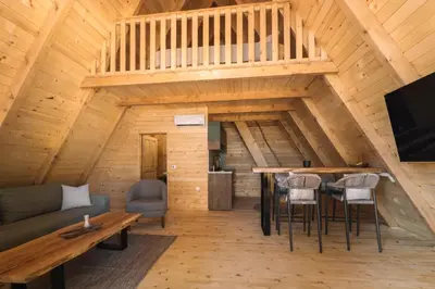 a living room with a couch and a table at Oak Cabin in Ulcinj