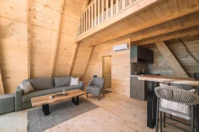 a living room with a couch and a table at Oak Cabin in Ulcinj