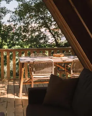 a wooden table and chairs on a patio at Oak Cabin in Ulcinj
