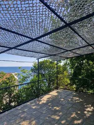 a screened in porch with a view of the ocean at MonaLiza in Ulcinj