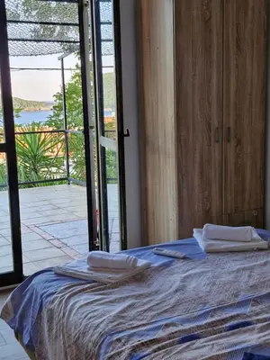a bedroom with a bed with towels on top of it at MonaLiza in Ulcinj