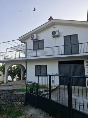 a white house with a fence and a gate at MonaLiza in Ulcinj
