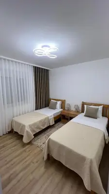 a room with two beds and a ceiling at Sea&Sun Living in Ulcinj