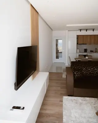 a living room with a flat screen tv on a wall at Sea&Sun Living in Ulcinj