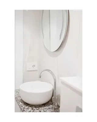 a white bathroom with a sink and a mirror at Sea&Sun Living in Ulcinj