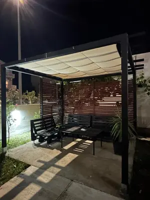a group of benches under a pavilion at night at Apartmani Rira in Sutomore