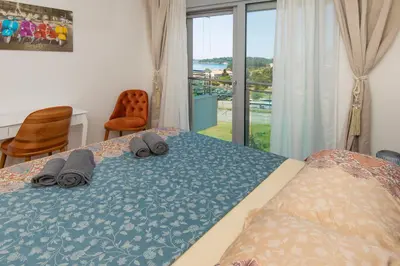 a bedroom with a bed with towels and a window at Lovely onebedroom Becici in Becici