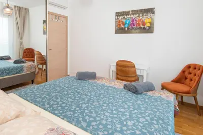 a bedroom with a bed with a blue blanket at Lovely onebedroom Becici in Becici