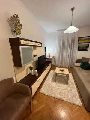 a living room with a couch and a tv at Apartman Kutak in Bar