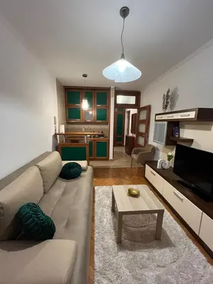 a living room with a couch and a table at Apartman Kutak in Bar