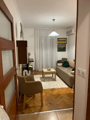 a living room with a couch and a chair at Apartman Kutak in Bar