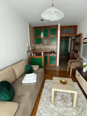 a living room with a couch and a table at Apartman Kutak in Bar