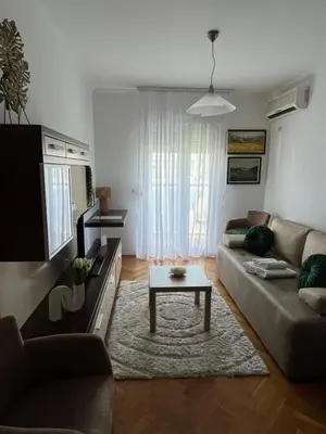 a living room with a couch and a coffee table at Apartman Kutak in Bar