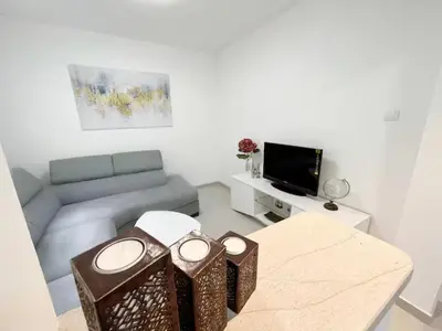 a living room with a couch and a table at Asia Apartments in Škaljari