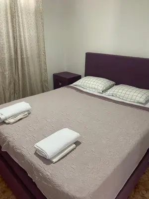 a bedroom with a bed with two white towels on it at Bigova Peace Oasis in Bigovo