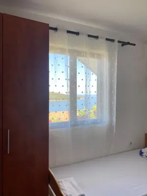 a bedroom with a window with a view of the ocean at Bigova Peace Oasis in Bigovo