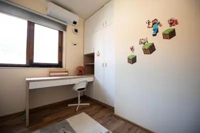 a room with a desk and a window at Heart of Budva 3BR City View Apt in Budva