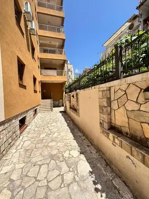 an empty alley between two buildings with a balcony at Heart of Budva 3BR City View Apt in Budva