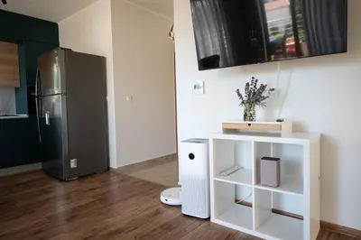 a kitchen with a refrigerator and a white cabinet at Heart of Budva 3BR City View Apt in Budva