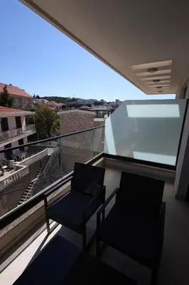 two chairs on a balcony with a view at Ornament Liman - Infinity Pool with Old Town View Apartments in Ulcinj