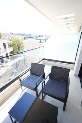 two chairs and a table on a balcony at Ornament Liman - Infinity Pool with Old Town View Apartments in Ulcinj